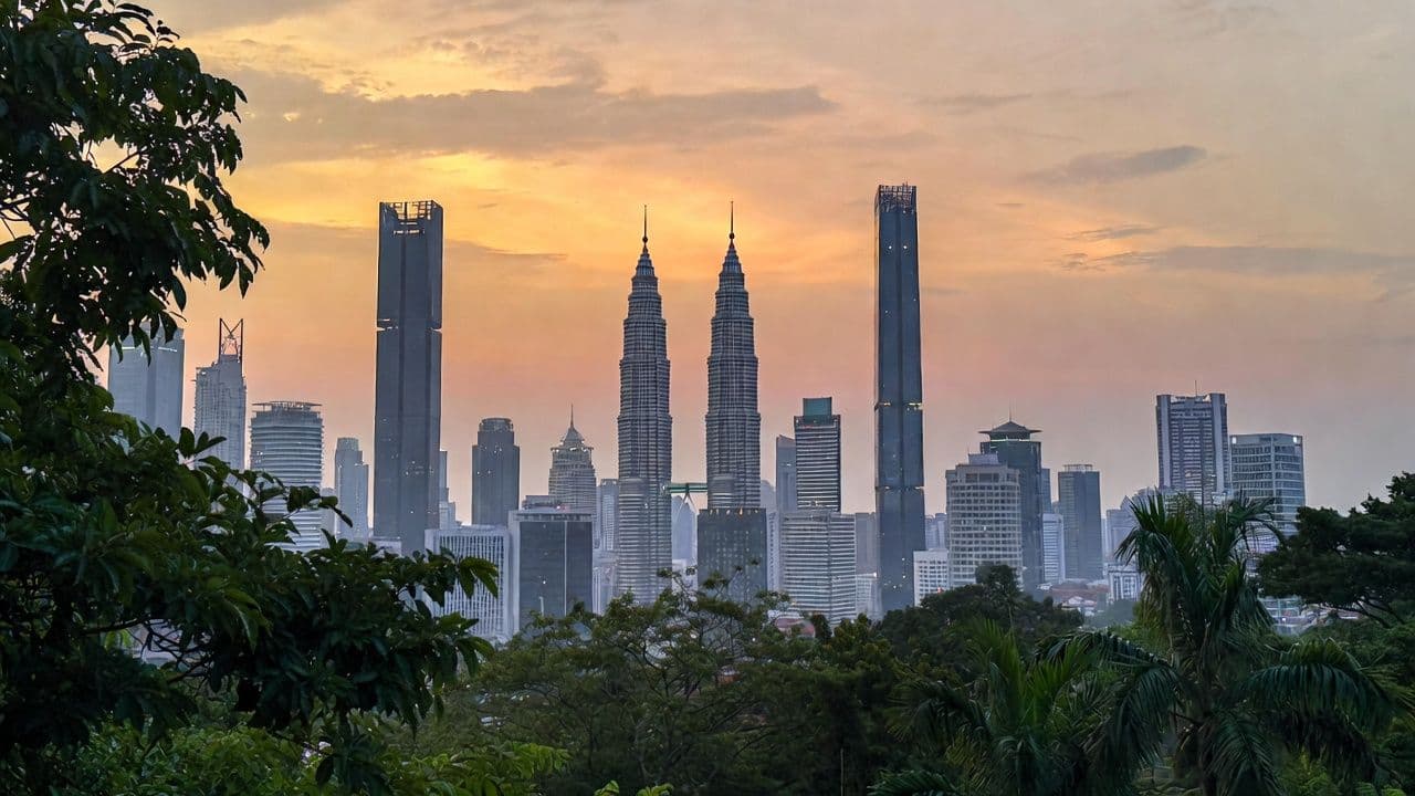 Kuala Lumpur skyline with Petronas Towers and surrounding high-rise condos in warm evening light
