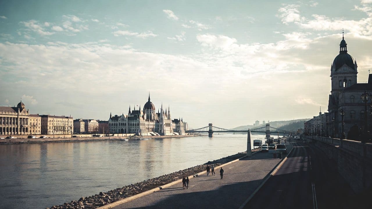 Budapest Danube riverbank with Parliament building and Chain Bridge in soft morning light